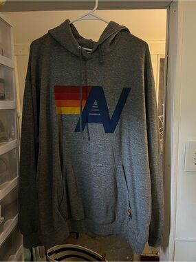 Aviator Nation Gray Hoodie with Blue AV and Red-Orange-Yellow Stripe